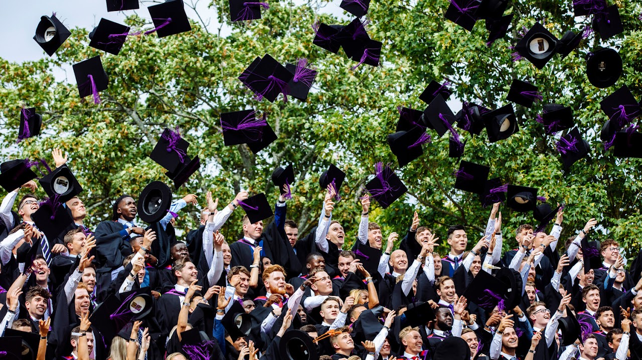 Graduating students throwing caps