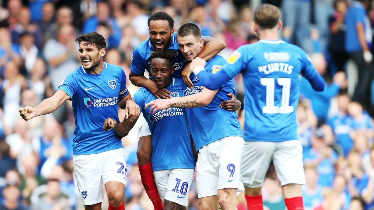 Portsmouth FC football players celebrating on the pitch